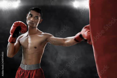 Boxer training with punching bag © fotokitas