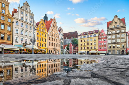 Old colorful buildings reflecting in a puddle on Rynek square in Wroclaw, Poland