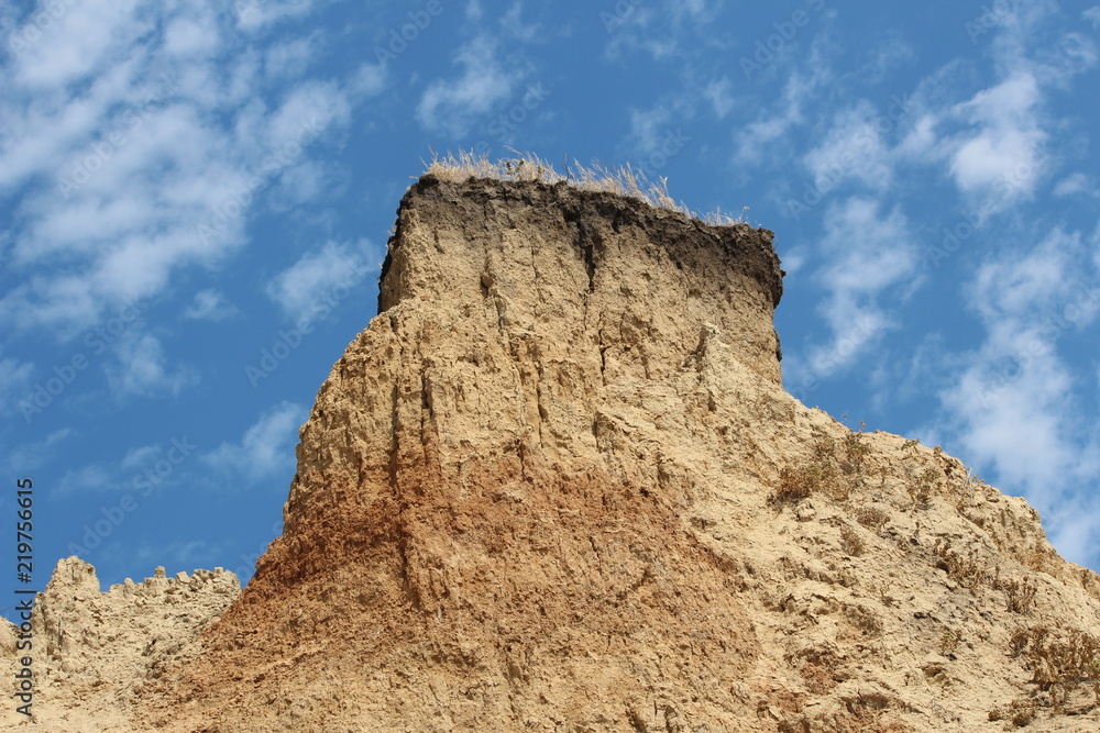 Rock of clay against the blue sky Rock of clay against the blue sky