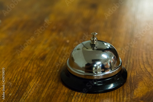 Hotel service call bell on wooden reception front desk