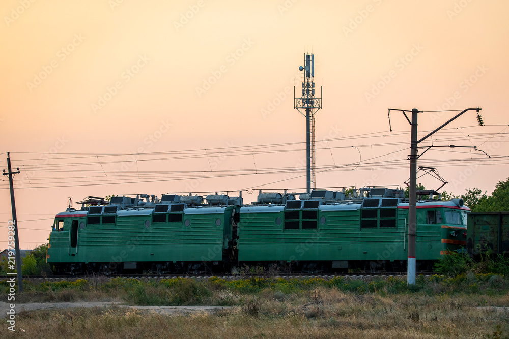 Russia, Merzhanovo: August 22, 2018: Locomotive electric with a freight train at high speed rides by rail Russia, Merzhanovo: August 22, 2018: Locomotive electric with a freight train at high speed rides by rail