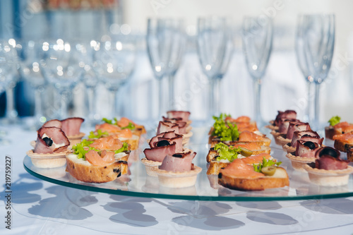 canape set with salmon fish and meat at luxury reception. catering food service
