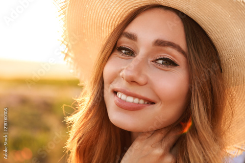 Close up of a lovely young girl in straw hat