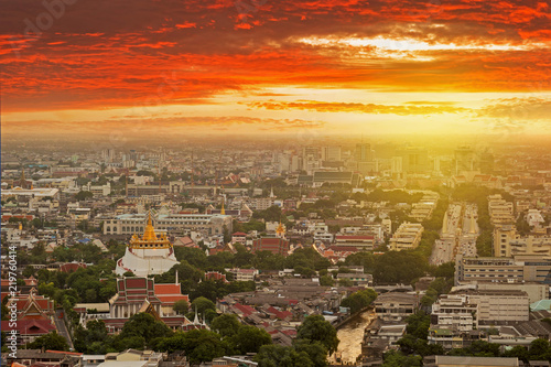 Bangkok skyline while sunset with Wat Saket temple view.