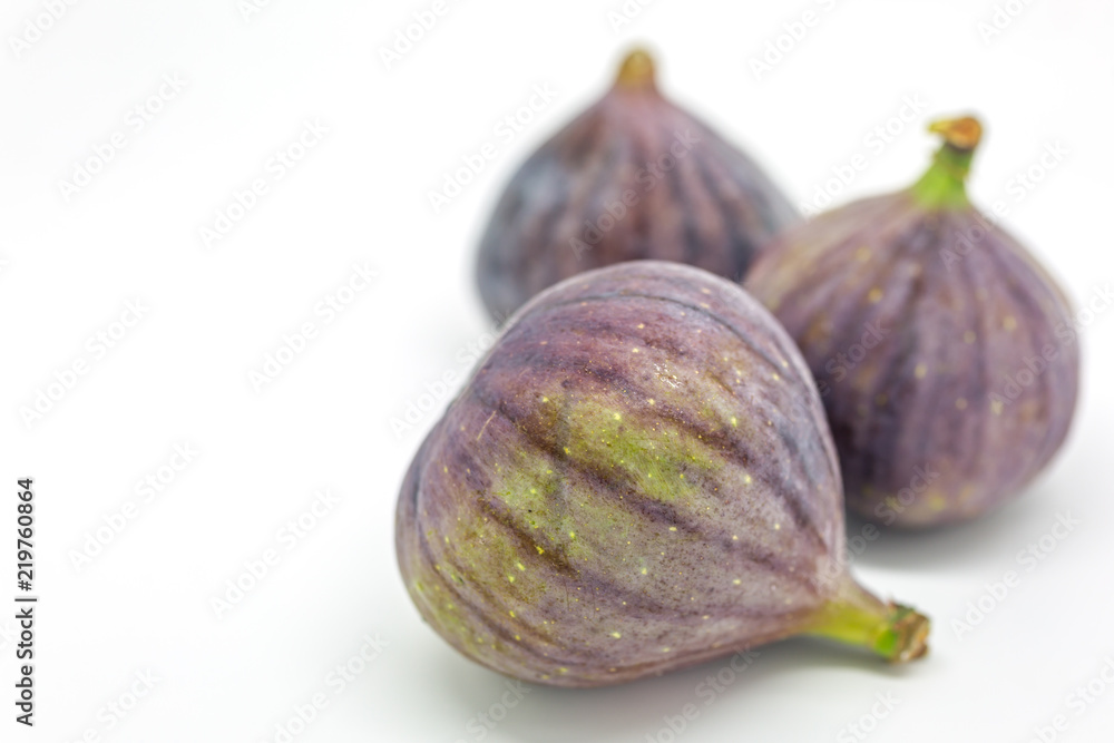 Whole figs against a white background, with a shallow depth of field Whole figs against a white background, with a shallow depth of field