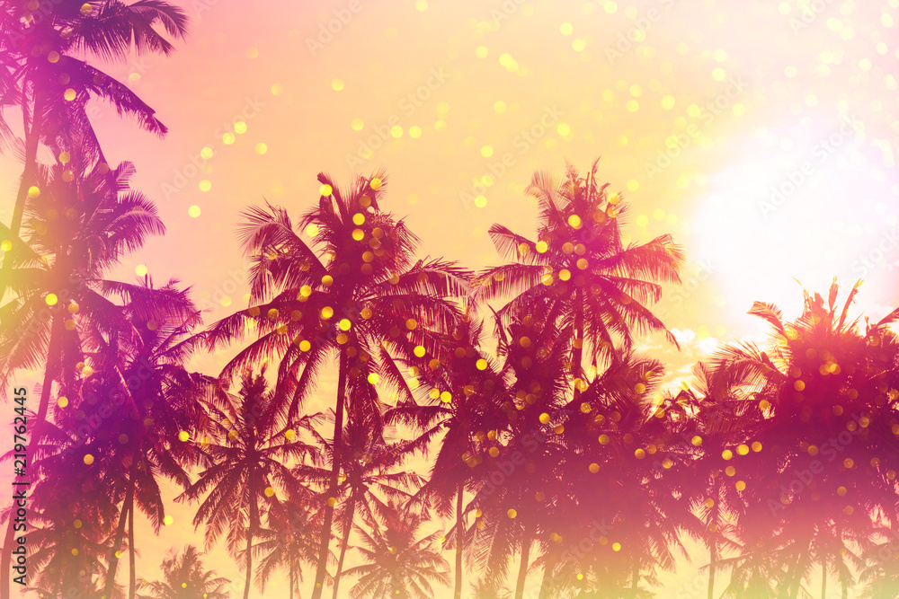 Palm sunset silhouettes stylized with light leaks and golden glitter