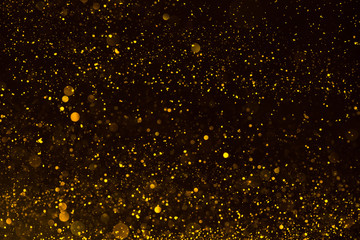 Shiny gold glitter particles abstract background