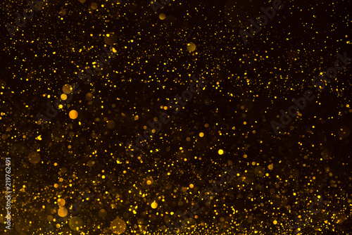 Shiny gold glitter particles abstract background