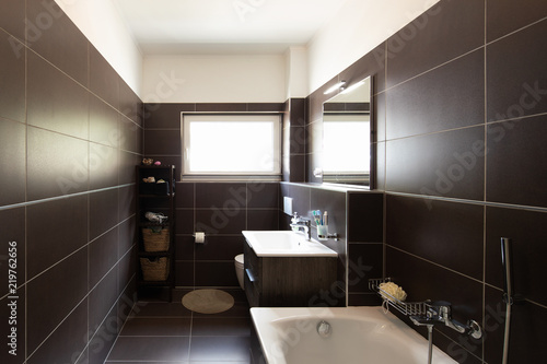 Modern bathroom with brown tiles and window