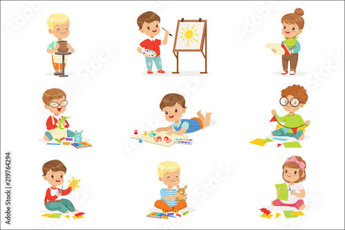 Little Kids In Art Class In School Doing Different Creative Activities, Painting , Working With Putty And Cutting Paper.