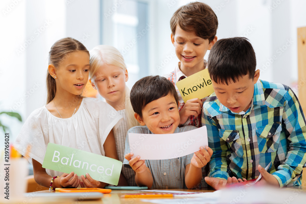 Leisure. Creative cute kids playing iteresting games while sitting in a classroom Leisure. Creative cute kids playing iteresting games while sitting in a classroom