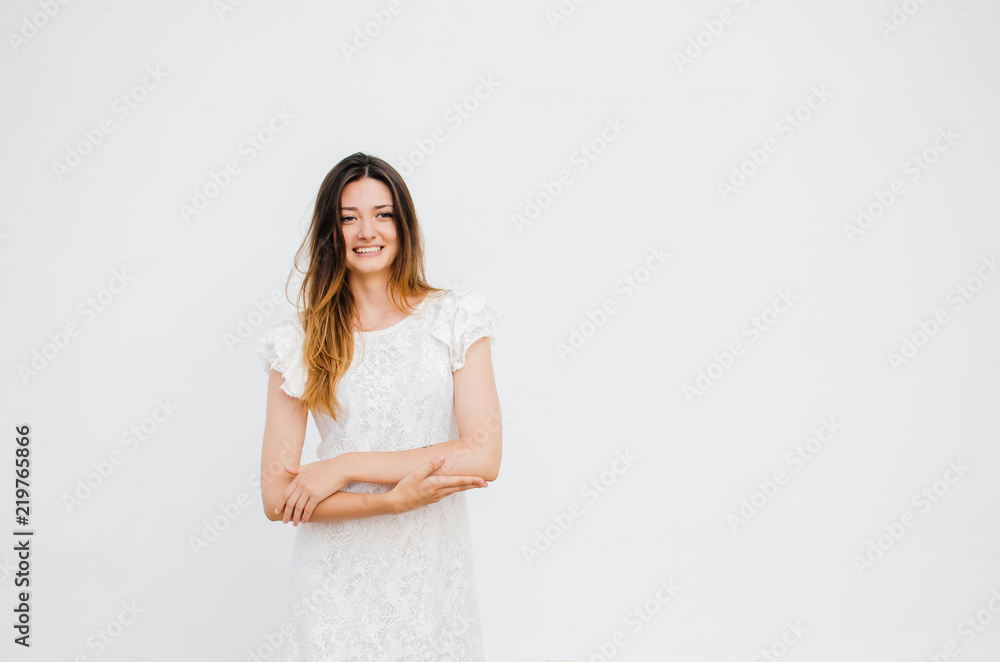 Beautiful woman in linen white dress posing isolated on grey background Beautiful woman in linen white dress posing isolated on grey background
