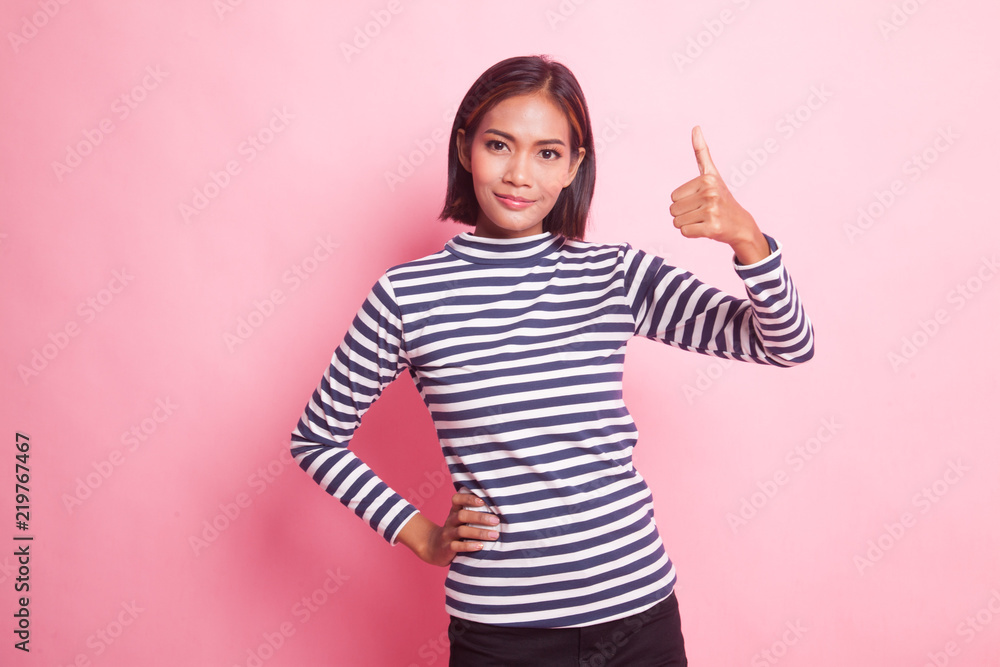 Young Asian woman show thumbs up. Young Asian woman show thumbs up.