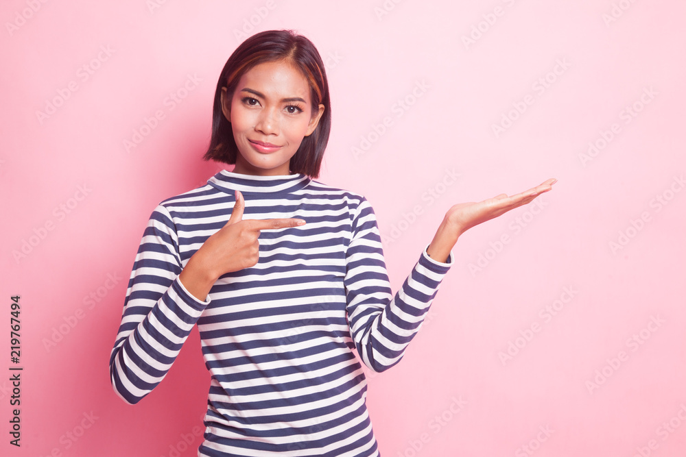 Beautiful young Asian woman point to palm hand. Beautiful young Asian woman point to palm hand.