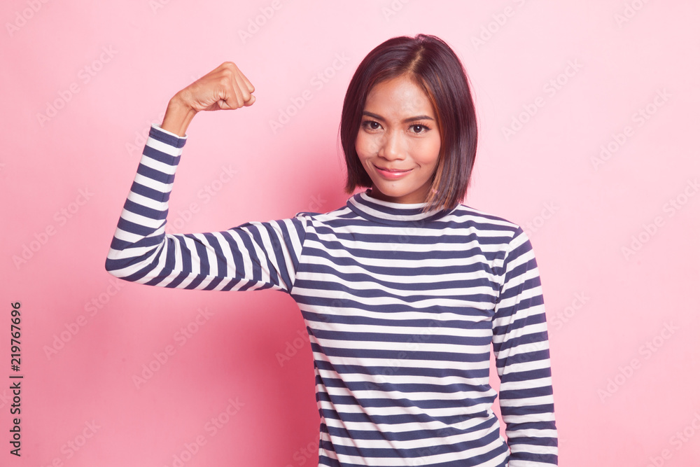 Beautiful young Asian woman flex bicep. Beautiful young Asian woman flex bicep.