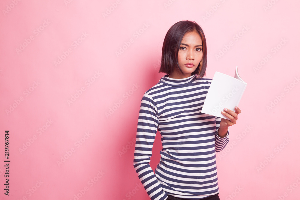 Young Asian woman with a book. Young Asian woman with a book.