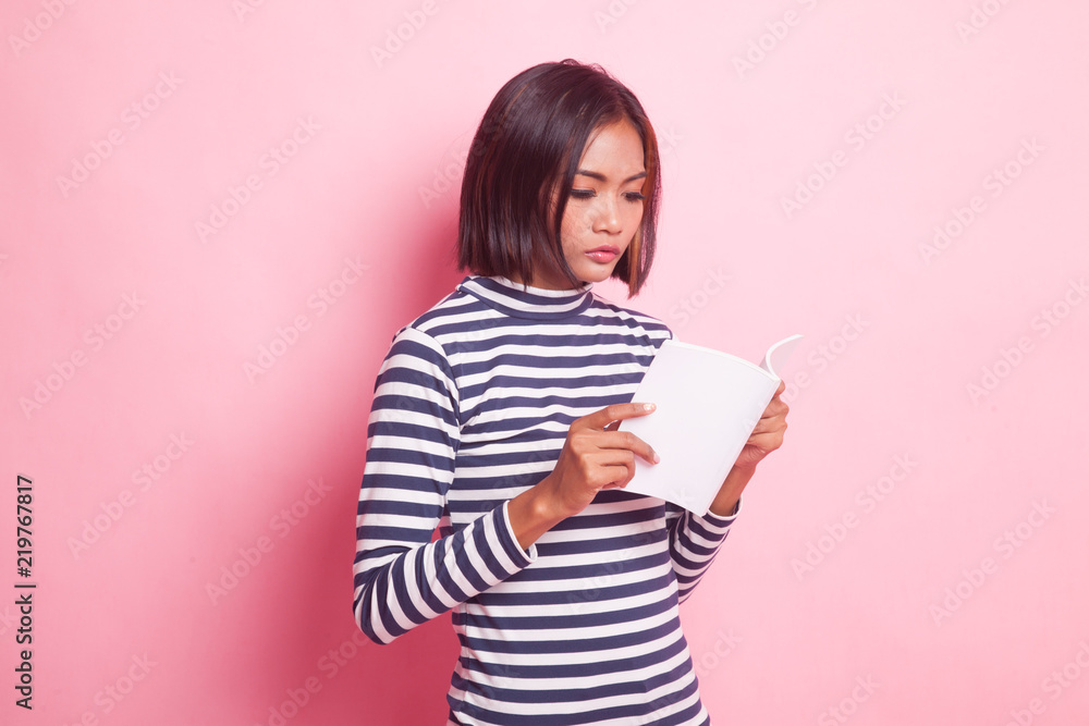Young Asian woman read a book. Young Asian woman read a book.