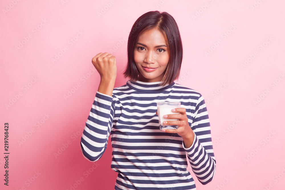 Healthy Asian woman drinking a glass of milk. Healthy Asian woman drinking a glass of milk.