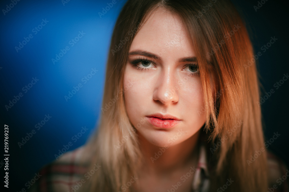 portrait smiling girl on blue background in studio portrait smiling girl on blue background in studio