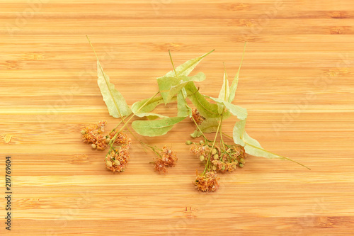 Dried linden flowers for linden tea on a bamboo surface
