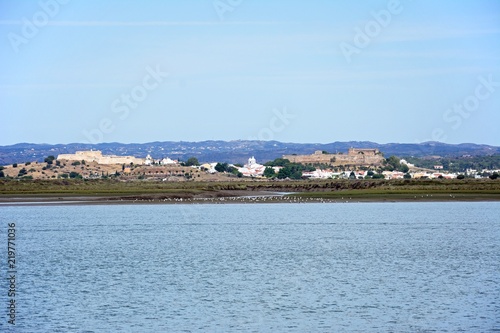 View across the River Guadiana towards the white town and its fort and castle, Castro Marim, Algarve, Portugal.