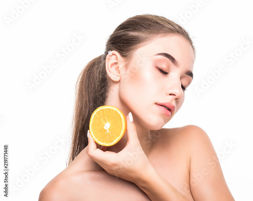 Young woman with citrus fructs in her hands isolated on white background. Skin care, cosmetology concept. photo