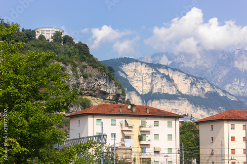 Hilltop mausoleum, mountains and buildings in Trento, Italy