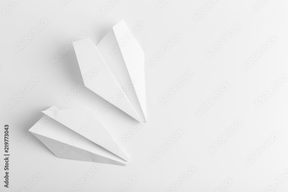 Flat lay of white paper plane on white color background Flat lay of white paper plane on white color background