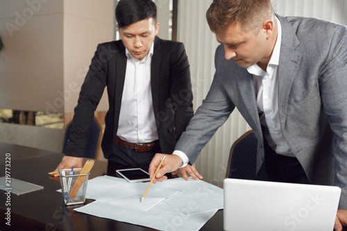 Confident team of engineers working together in a architect studio.