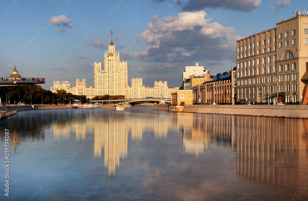 Fototapeta premium Moskvoretskaya embankment and high-rise building on the Kotelnicheskaya embankment and Moskva-river. Winter cityscape. Moscow, Russia