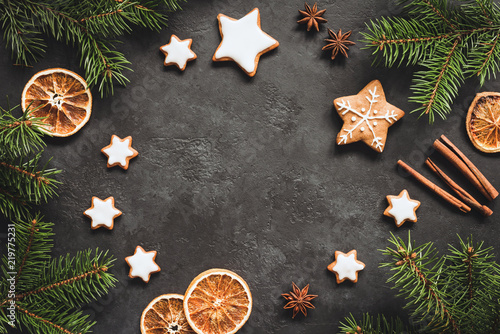 Christmas or New Year 2019 Frame Background. Gingerbread cookies, spices, fir tree and cinnamon on concrete background. Copy space for text