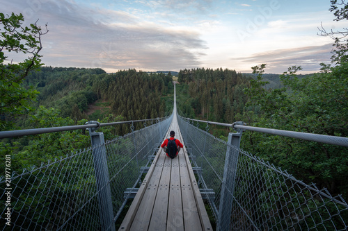 Fototapeta Naklejka Na Ścianę i Meble -  Traveler on the suspension bridge in Germany. Geierlay, Morsdorf.