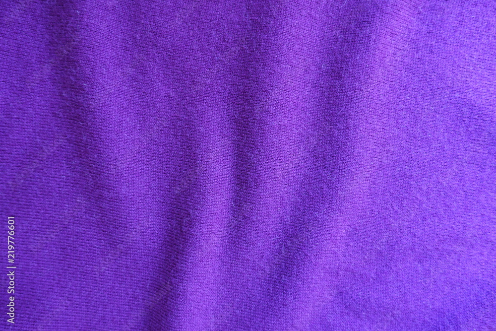 Wavy folds on thin violet knitted fabric Wavy folds on thin violet knitted fabric