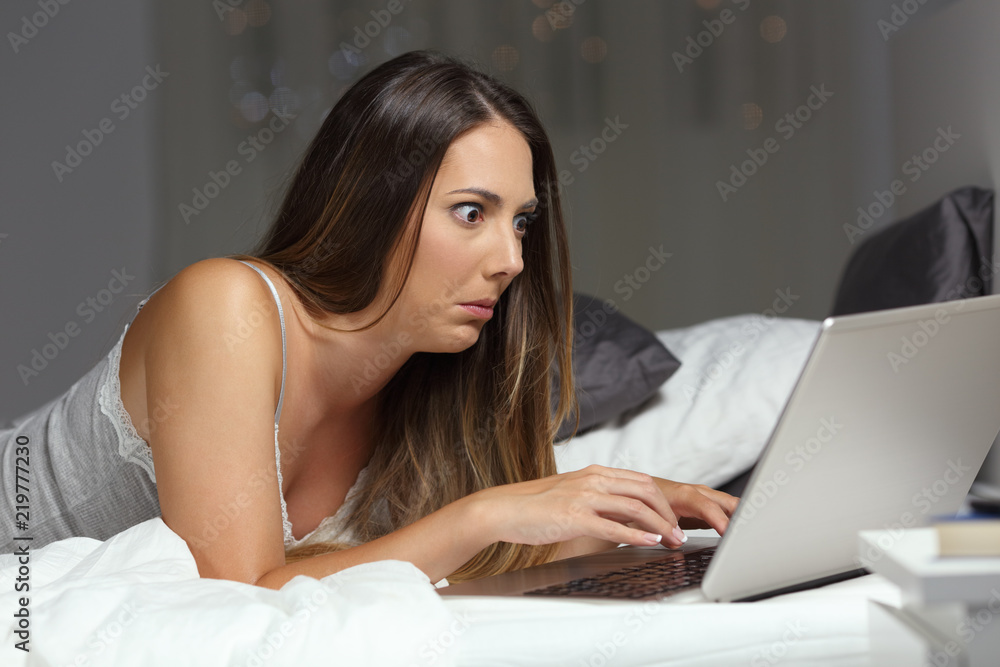 Confused woman reading email at home Confused woman reading email at home