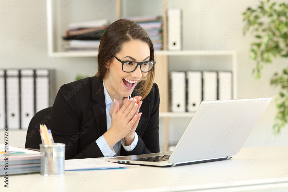 Hopeful office worker watching online content Hopeful office worker watching online content