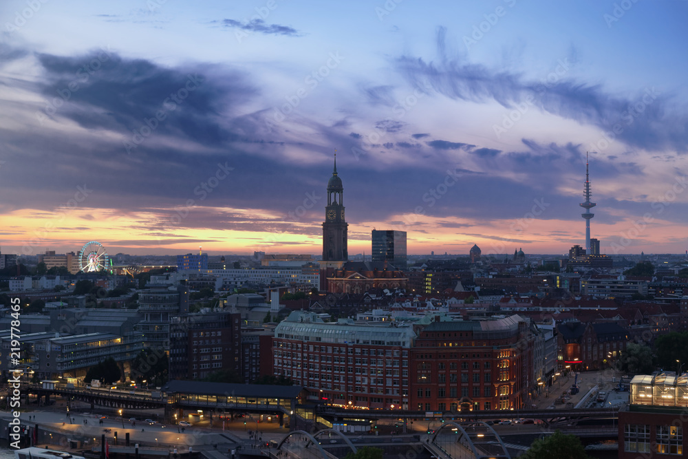 Hamburg's landmarks at sunset - Ferries Wheel of Hamburg's Dom, St. Michael's church and television tower