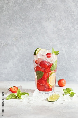 Strawberry infused water, coctail, lemonade or tea. Summer iced cold drink with strawberry, lemon and mint. Selective focus  photo