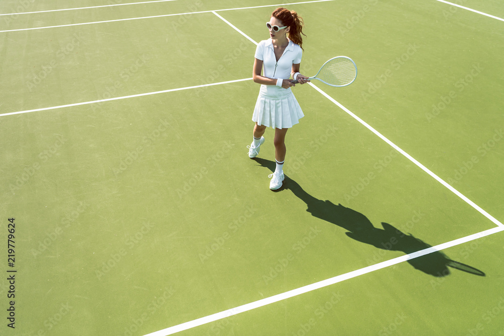 © LIGHTFIELD STUDIOS - side view of young attractive woman in white tennis uniform playing tennis on court © LIGHTFIELD STUDIOS - side view of young attractive woman in white tennis uniform playing tennis on court