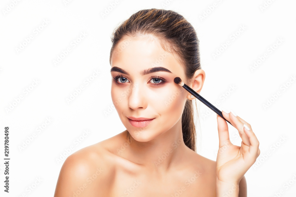 Facial Makeup. Closeup Of Beautiful Young Female Model Putting Blush With Cosmetic Brush. Portrait Of Attractive Healthy Girl With Pure Clean Skin And Natural Make-Up. Beauty Concept.