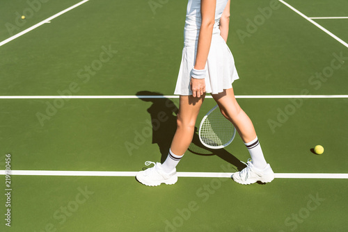 partial view of female tennis player in white sportswear with racket on tennis court © LIGHTFIELD STUDIOS