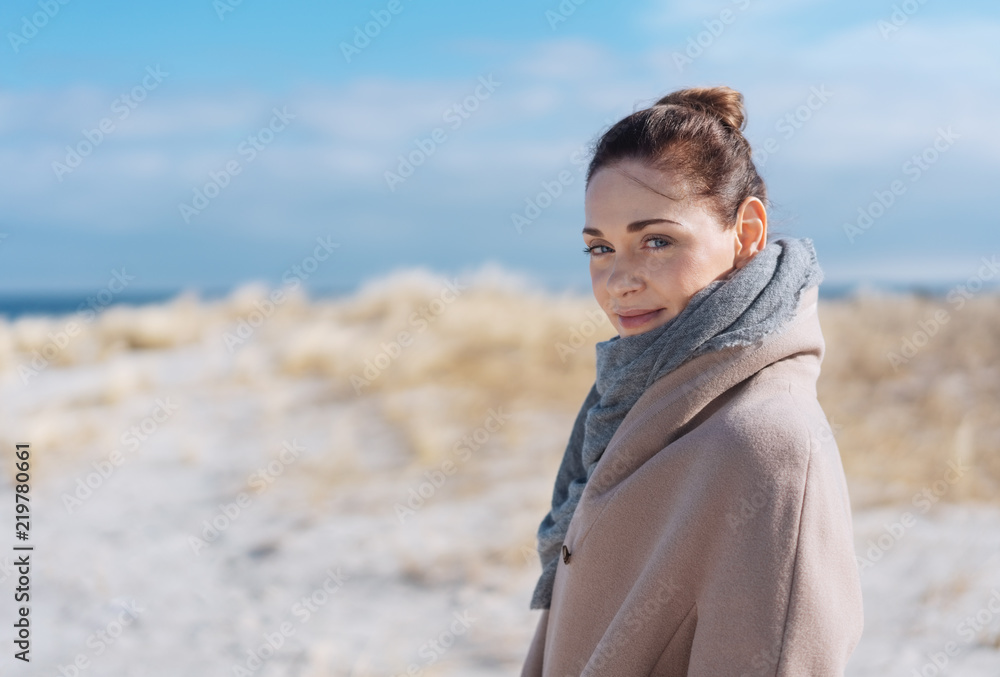 Attractive woman on a sunny sandy winter beach Attractive woman on a sunny sandy winter beach