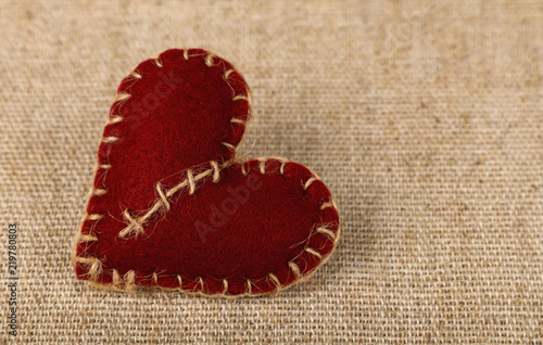 Bild auf Leinwand Brown felt craft heart over canvas close up