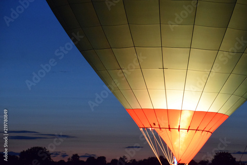 single air balloon with burner close-up, hot air balloon with a yellow fire from a burner by night