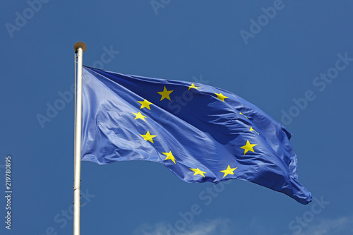 Close up flag of EU waving in wind over blue sky