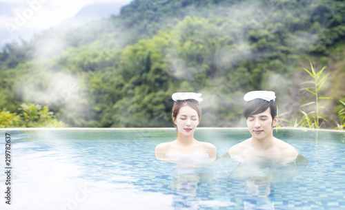 Young asian couple relaxing in hot springs