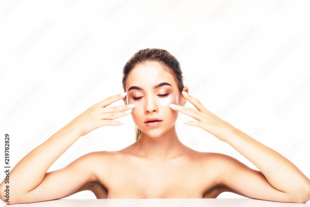 Beauty portrait of relaxed woman with brunette hair wearing cosmetic patches under both eyes isolated over white background Beauty portrait of relaxed woman with brunette hair wearing cosmetic patches under both eyes isolated over white background