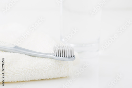 Clean toothbrush and a glass of water.