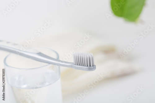 Clean toothbrush and a glass of water.