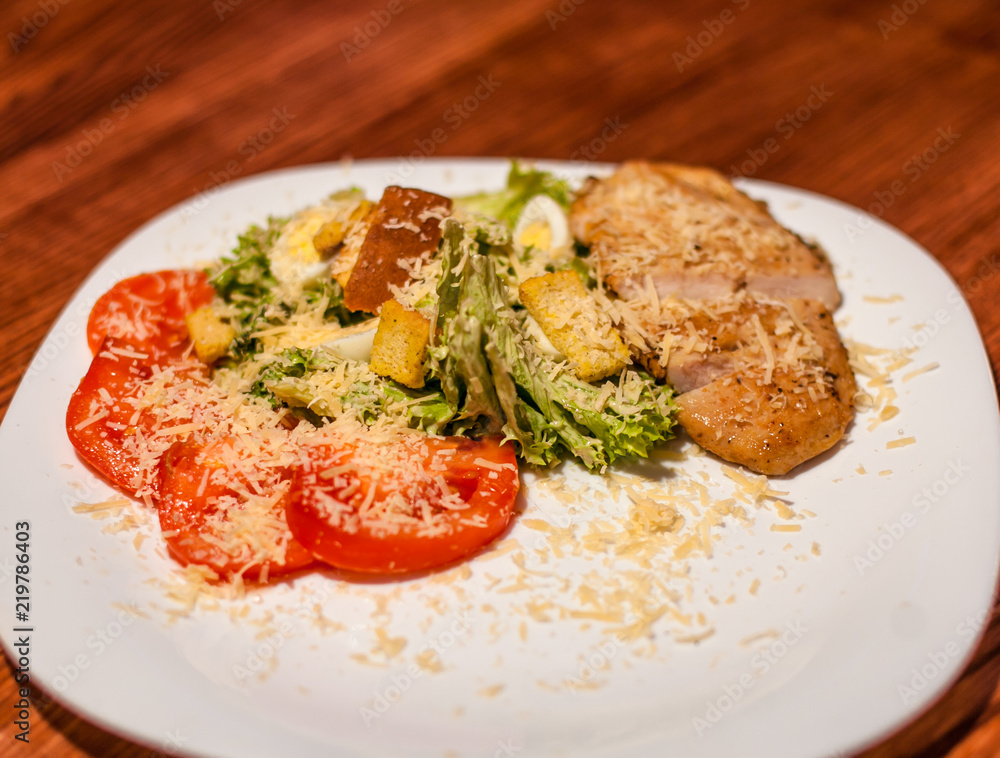 Grilled beef steaks on a plate with different vegetables