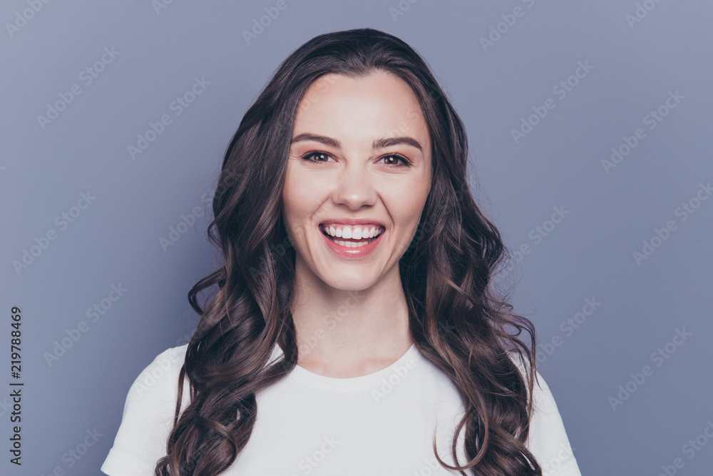 Close-up portrait of adorable attractive nice charming gorgeous curly-haired brunette caucasian laughing cheerful young girl. Isolated over grey background Close-up portrait of adorable attractive nice charming gorgeous curly-haired brunette caucasian laughing cheerful young girl. Isolated over grey background